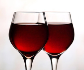Two red wine glasses on white