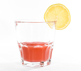Red cocktail in whiskey glass over white background.