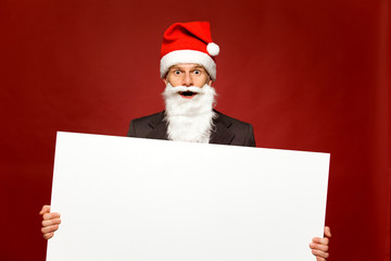 Santa holding blank poster
