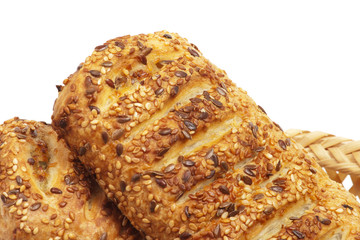 pasties with sesame seeds in wattled basket