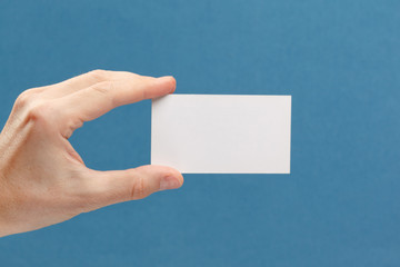 businessman's hand holding blank white paper business card