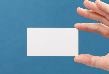 Fototapeta premium businessman's hand holding blank white paper business card