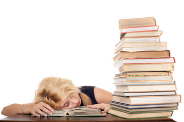 schoolgirl sleeping near book stack