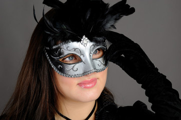 Beautiful sexy woman in party carnival mask . isolated on gray b