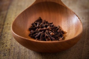 Cloves in a wooden spoon