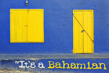Colorful blue house with yellow doorway and window
