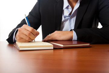 Businessman writing on the agenda in his office