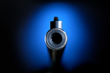 Gun barrel on blue pointing straight on