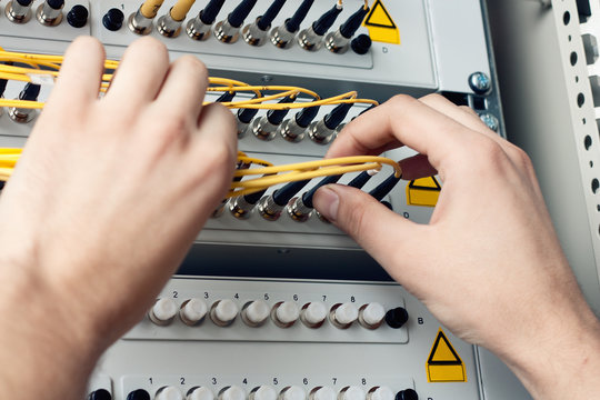 Engineer of ISP Internet Service Provider hold fiber patch cords