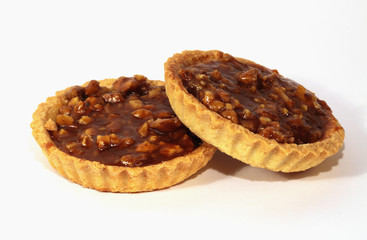 Two caramel tarts with Circassian walnut isolated