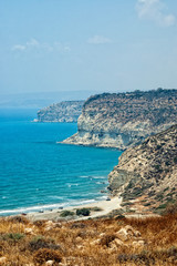 Fototapeta na wymiar Kourion coast with blue sea and sky with clouds.