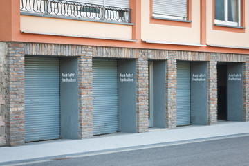 Row of garages with 1 open