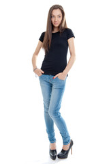 Standing young woman with jeans and high heels