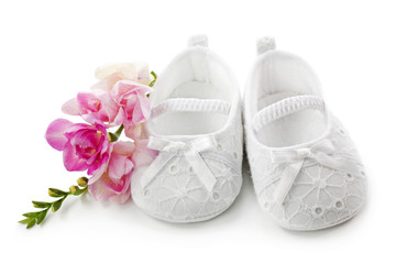 Baby girl shoes with pink flowers isolated on white background