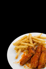 Hot Chicken Wings and Fries Isolated on Black Background