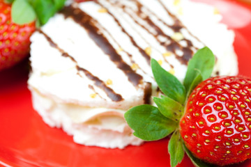 cake and strawberries lying on the orange fabric