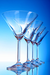 empty glasses of martini on the light blue background
