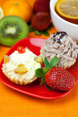 lemon,lemon tea,mandarin,kiwi,cake and strawberries lying on the