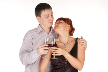 Young loving couple with red wine glasses in hands