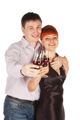 Young loving couple with red wine glasses in hands