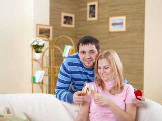 couple with glasses of champagne at home