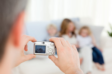 Man taking a photo of his family