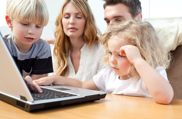 Fototapeta na wymiar Family looking at their laptop