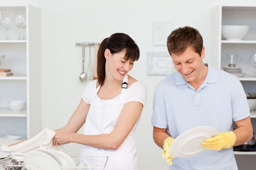 Fototapeta premium Lovers washing dishes together