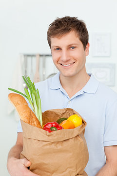 Man with shoping bags in the kitchen