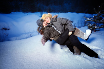 Pretty couple is playing in the snow