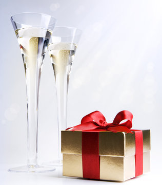 two glasses of champagne and a gift