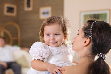 young mother with a daughter at home