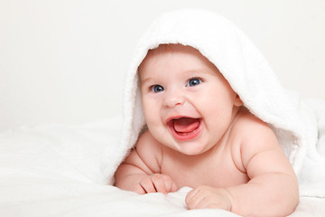 Laughing baby with towel