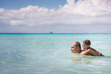 father and son playing in water
