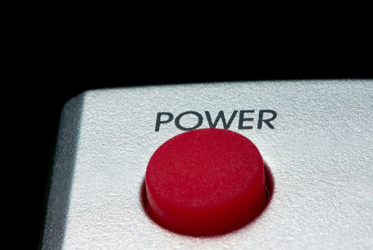 Big red Power button isolated on black