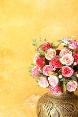 Obraz na płótnie Canvas Pot of romantic pink roses on vintage painted background