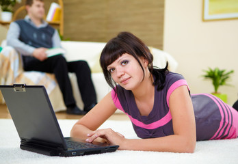 young woman with a laptop at home