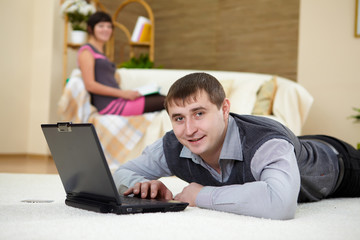 young man with a laptop at home