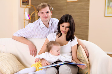 Obraz premium young family at home playing with a baby