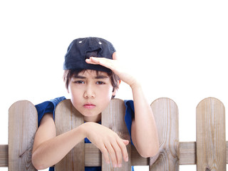 child looking over a fence