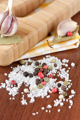 Seasalt and colorful pepper on a wooden table