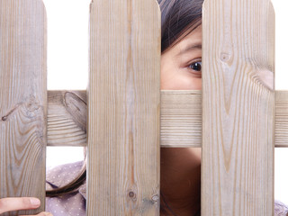 girl peeking through the fence