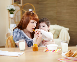 mother feeding a baby at home