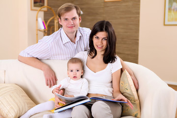 Obraz premium young family at home playing with a baby