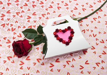 Paper package with heart symbol and rose