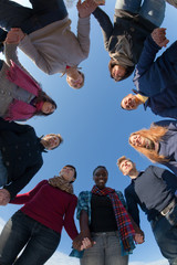 Multiracial People Holding Hands in a Circle, Low Angle View