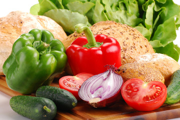 Composition with bread and vegetables on breadboard