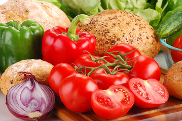 Composition with bread and vegetables on breadboard