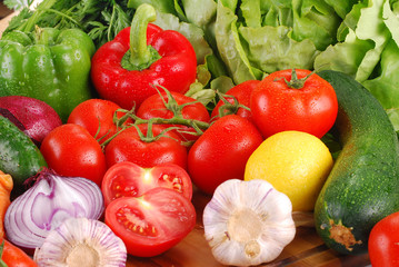 Composition with variety of raw vegetables on breadboard
