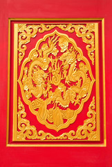 Fototapeta na wymiar golden dragon decorated on red wood in chinese temple,Nonthaburi